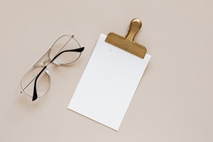 Composition of glasses and clip on beige background picture